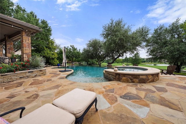 view of swimming pool with a patio and a pool with connected hot tub