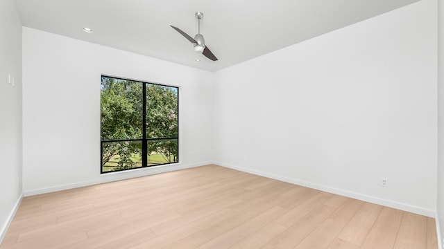 unfurnished room with a ceiling fan, baseboards, recessed lighting, and light wood-style flooring