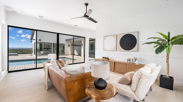 living room with ceiling fan, recessed lighting, light wood-style flooring, and visible vents