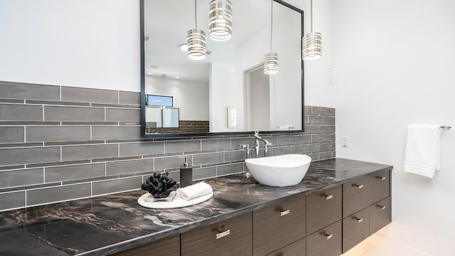 bathroom with vanity and tasteful backsplash
