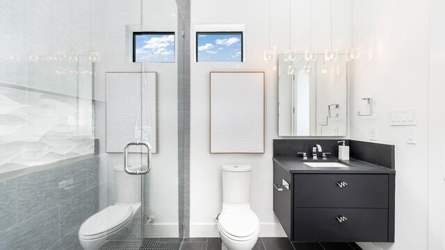 full bath with vanity, a stall shower, and toilet