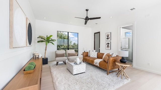 living area with baseboards, a ceiling fan, recessed lighting, and visible vents