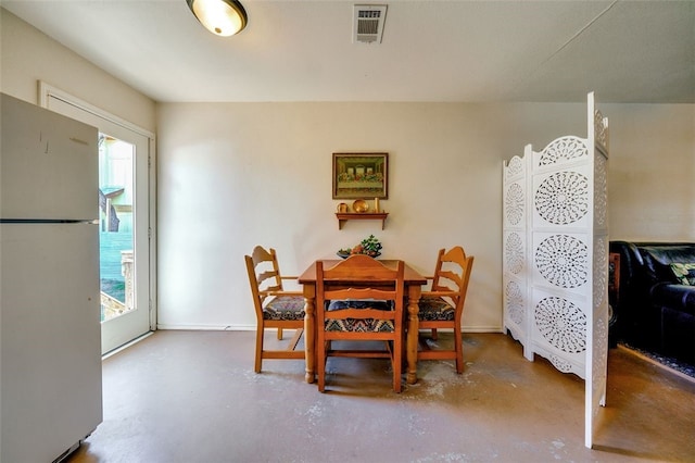 dining room with visible vents and finished concrete floors