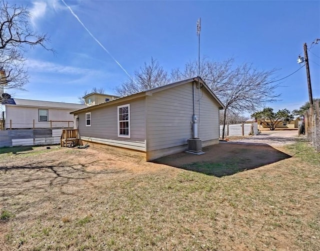 back of property with a yard and fence