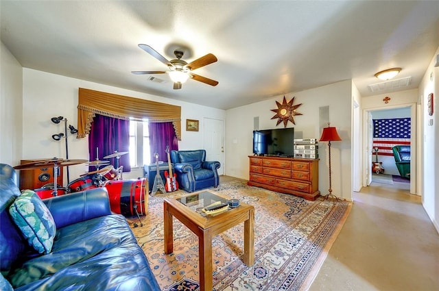living area featuring finished concrete flooring, ceiling fan, and visible vents