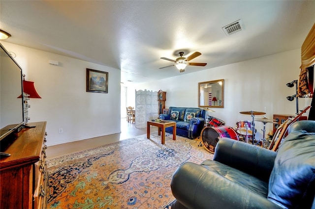 living area featuring visible vents and ceiling fan