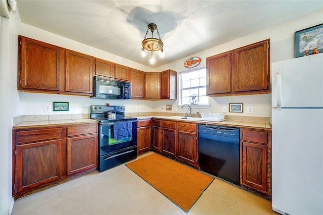 kitchen featuring tile counters, a sink, and black appliances