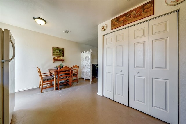 dining area with concrete flooring, baseboards, and visible vents