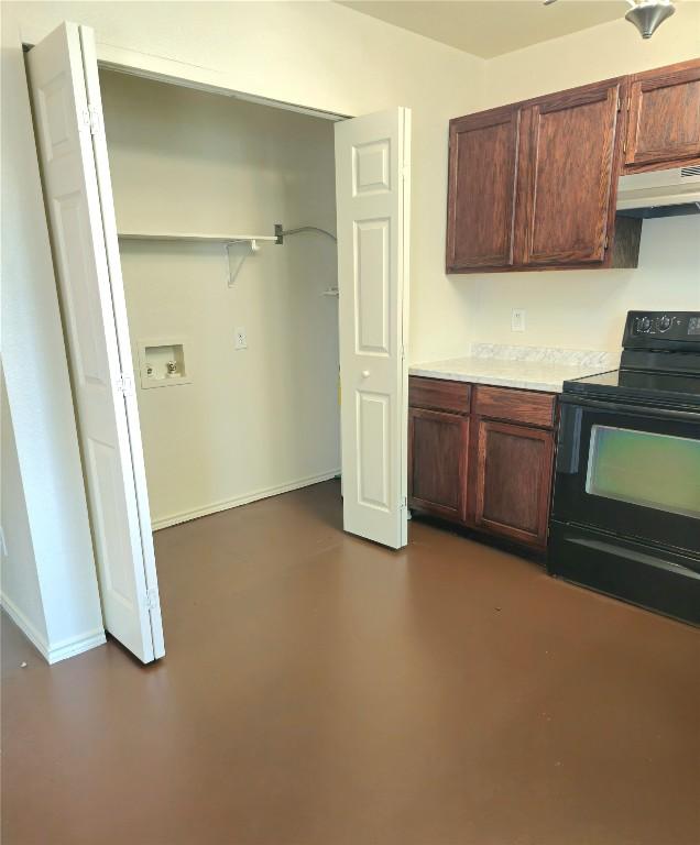 6637 River Oaks Dr, Kingsland, TX 78639 - kitchen featuring black electric range, under cabinet range hood, light countertops, concrete flooring, and baseboards