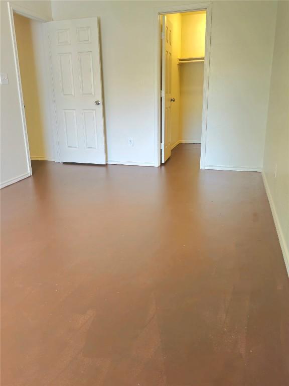 6637 River Oaks Dr, Kingsland, TX 78639 - unfurnished bedroom with baseboards, a spacious closet, and a closet