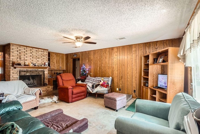living area with carpet flooring, a ceiling fan, a textured ceiling, and wood walls