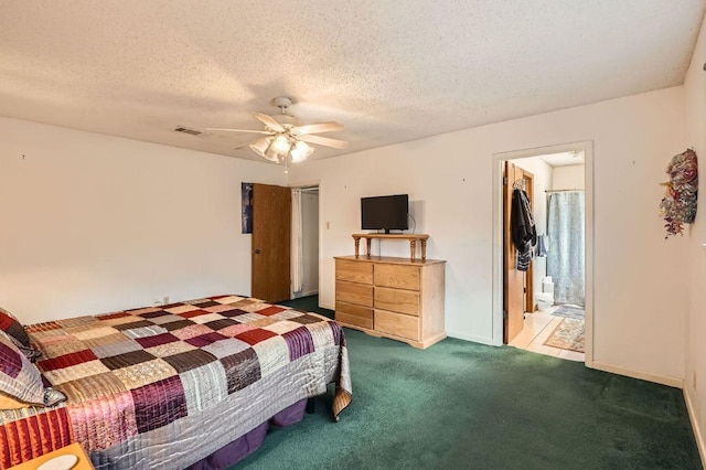 carpeted bedroom with visible vents, a textured ceiling, and ceiling fan