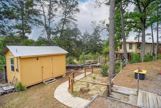 125 Turkey Trot Rd, Smithville, TX 78957 - view of yard with an outdoor structure, a garden, a shed, and fence