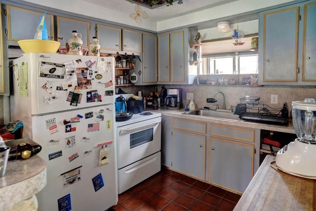 125 Turkey Trot Rd, Smithville, TX 78957 - kitchen with white appliances, dark tile patterned floors, light countertops, a sink, and backsplash