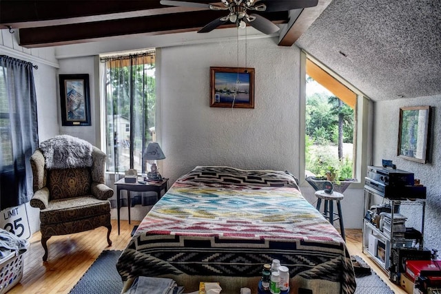 125 Turkey Trot Rd, Smithville, TX 78957 - bedroom with a textured wall, lofted ceiling with beams, and wood finished floors
