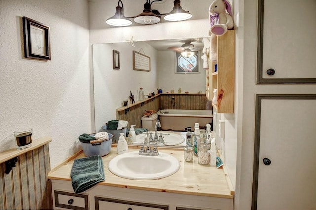 125 Turkey Trot Rd, Smithville, TX 78957 - bathroom with vanity, a textured wall, and ceiling fan