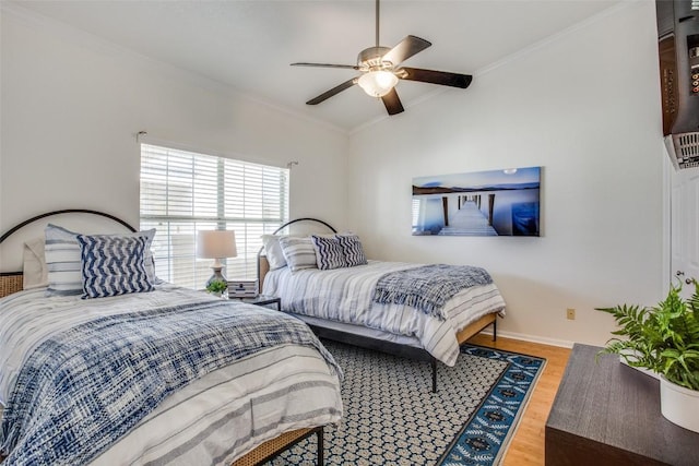 3404 American Dr Unit 2306, Lago Vista, TX 78645 - bedroom with crown molding, ceiling fan, baseboards, wood finished floors, and vaulted ceiling