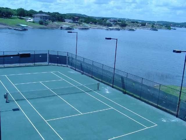 3404 American Dr Unit 2306, Lago Vista, TX 78645 - view of sport court with a water view and fence