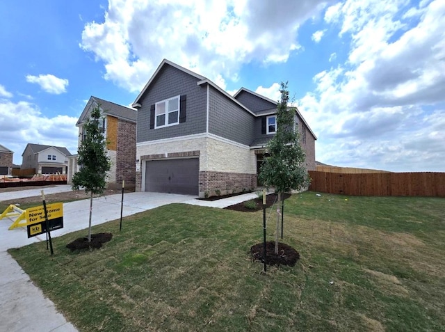 view of side of home featuring a garage, fence, stone siding, concrete driveway, and a lawn