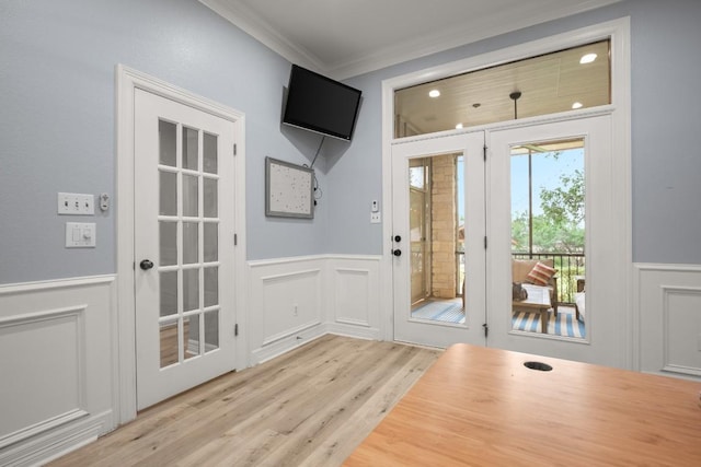 doorway featuring a decorative wall and wainscoting