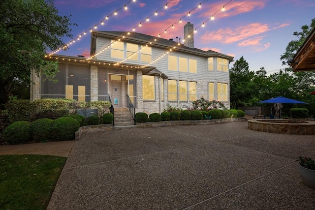 view of front of property featuring a chimney and stone siding