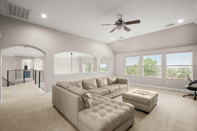 living area featuring light carpet, vaulted ceiling, and visible vents