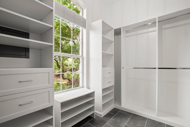 spacious closet with dark tile patterned flooring