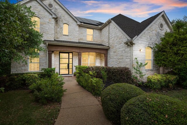 601 Scenic Path, Leander, TX 78641 - french provincial home with stone siding and roof mounted solar panels