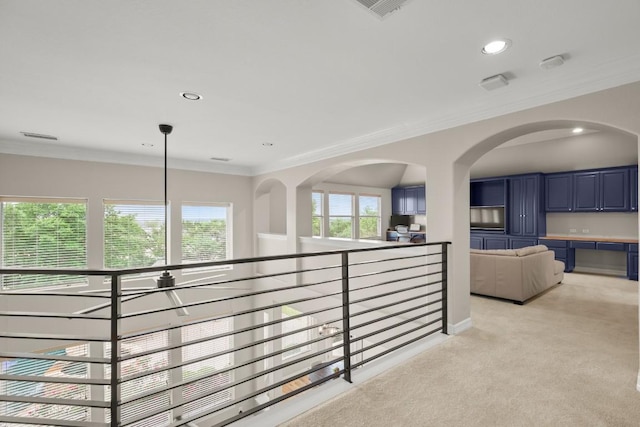 hallway featuring crown molding, visible vents, recessed lighting, and light colored carpet