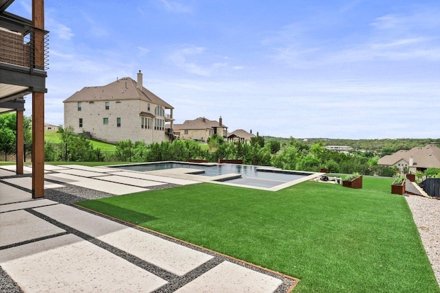 view of yard with a residential view, fence, a patio area, and an outdoor pool