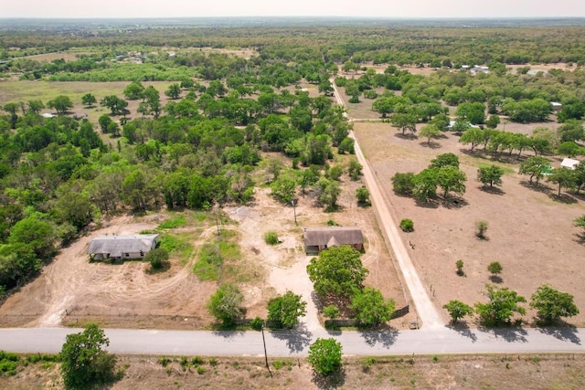 birds eye view of property featuring a rural view and a wooded view