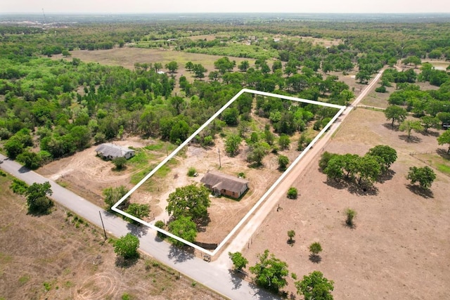 birds eye view of property featuring a rural view and a wooded view