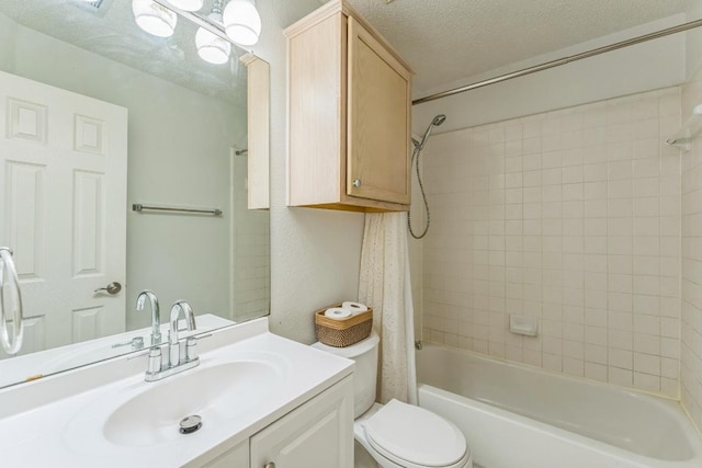 full bath featuring washtub / shower combination, vanity, toilet, and a textured ceiling