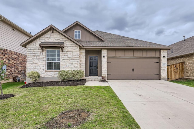 view of front of property featuring board and batten siding, driveway, a front lawn, an attached garage, and stone siding