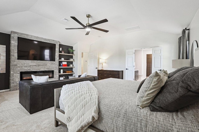 bedroom featuring visible vents, carpet flooring, vaulted ceiling, and a fireplace