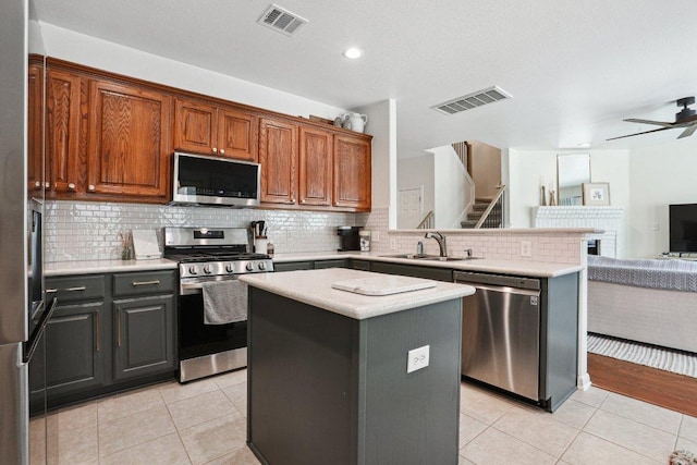 kitchen with light tile patterned flooring, open floor plan, appliances with stainless steel finishes, and visible vents