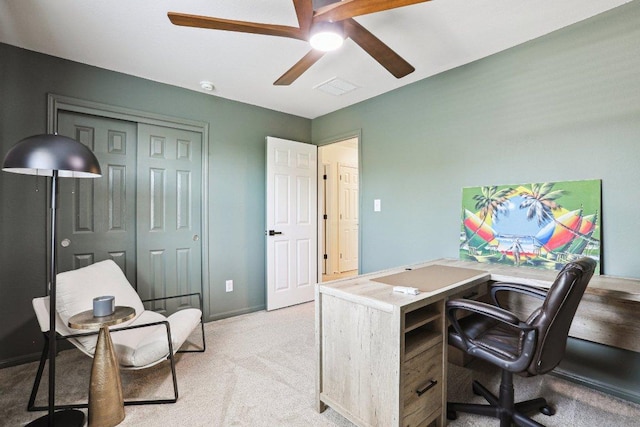 office space with ceiling fan, light carpet, and baseboards