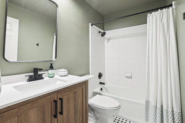 full bath featuring toilet, a textured wall, shower / bath combo with shower curtain, and vanity