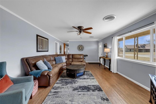 1309 E Brown St, Llano, TX 78643 - living room with ceiling fan, wood finished floors, and ornamental molding