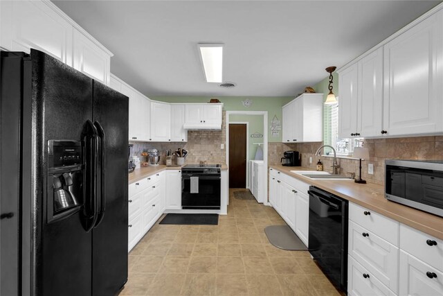 1309 E Brown St, Llano, TX 78643 - kitchen with black appliances, light countertops, and white cabinets