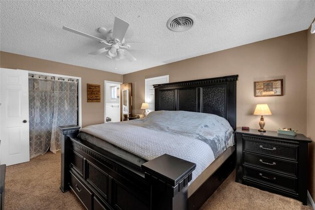 1309 E Brown St, Llano, TX 78643 - bedroom featuring light carpet, a textured ceiling, and a ceiling fan
