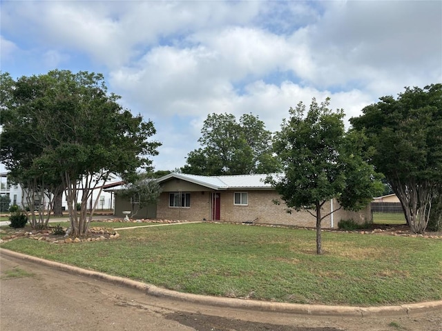 1309 E Brown St, Llano, TX 78643 - view of front facade with metal roof and brick siding