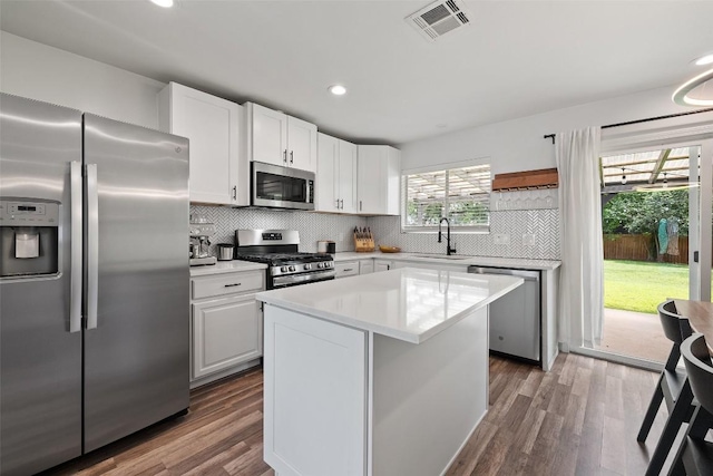 kitchen featuring visible vents, a sink, decorative backsplash, and stainless steel appliances