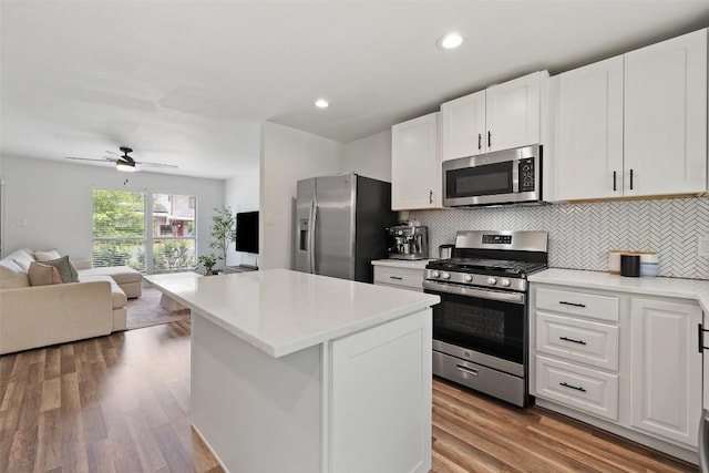 kitchen featuring open floor plan, appliances with stainless steel finishes, backsplash, and light countertops