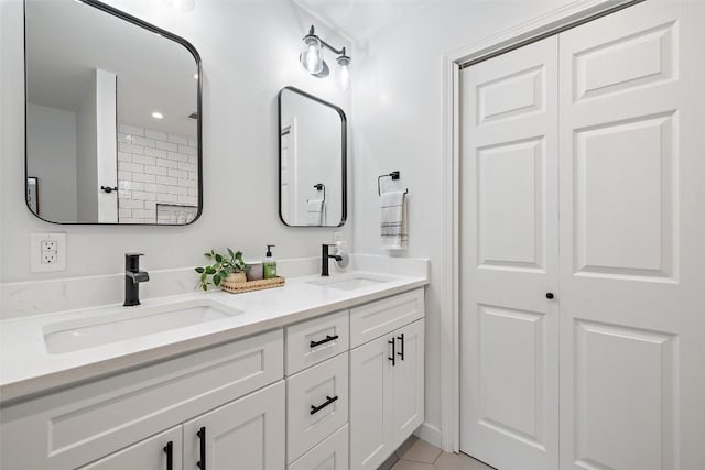 full bathroom with a sink and double vanity