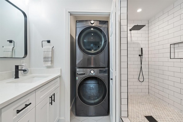 laundry area with stacked washing maching and dryer, laundry area, and a sink