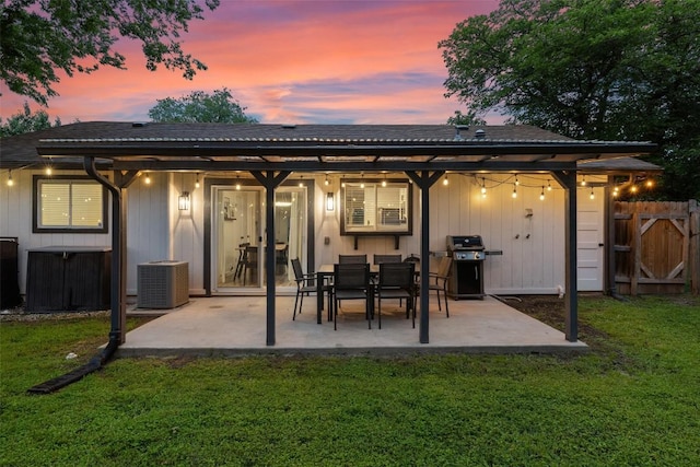 back of house featuring a patio, central air condition unit, a yard, and fence