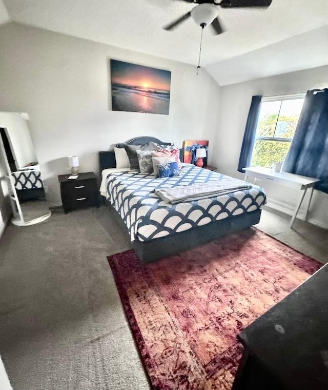 bedroom with a ceiling fan, carpet, and vaulted ceiling