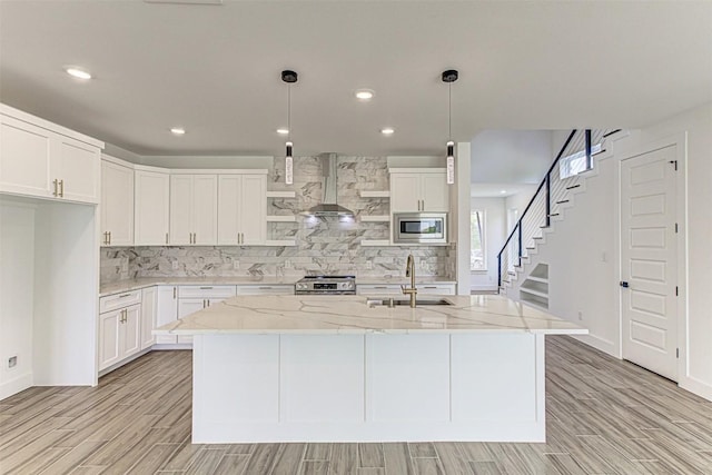 141 Awehi Ln, Bastrop, TX 78602 - kitchen with appliances with stainless steel finishes, a sink, light wood-style floors, tasteful backsplash, and recessed lighting