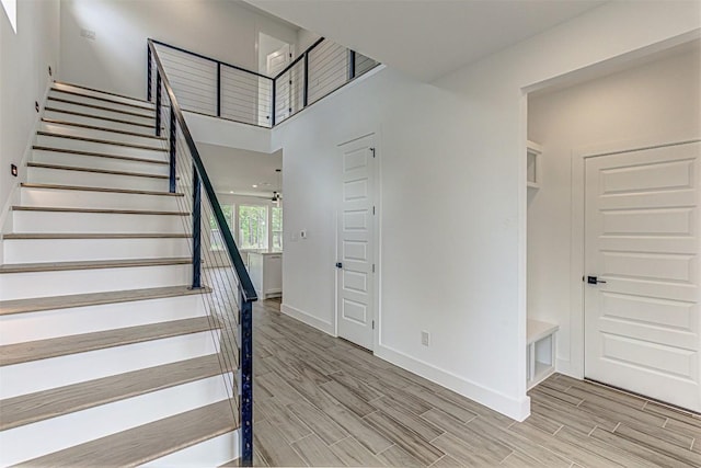 141 Awehi Ln, Bastrop, TX 78602 - stairway with wood finished floors and a towering ceiling